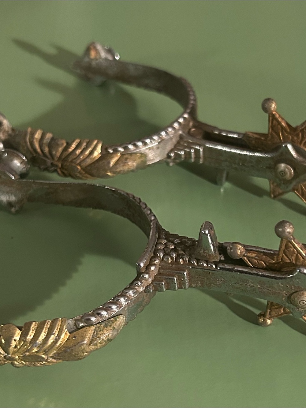 Vintage Two-Tone Metal Spurs with Decorative Leaf Motif